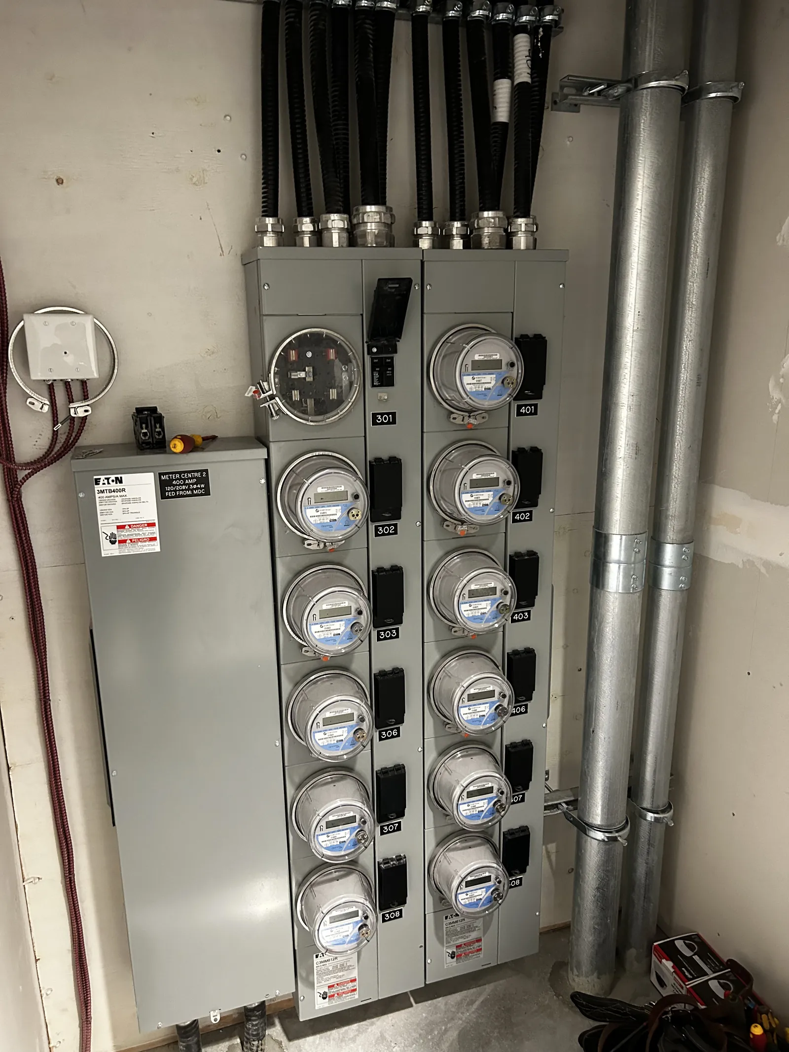 A bank of tenant electrical meters serving a multifamily building.